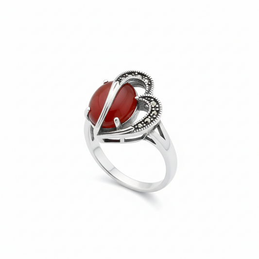 Silver ring with a red stone on a white background | Allure Trinkets
